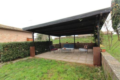 a pavilion with two chairs and a table in a yard at Suite la Rosa in Colle Malamerenda