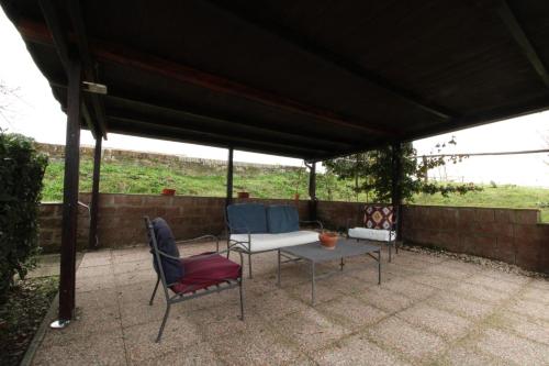 a patio with two chairs and a table under a pavilion at Suite la Rosa in Colle Malamerenda