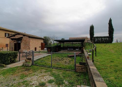 a fence in front of a building with a pavilion at Suite la Rosa in Colle Malamerenda
