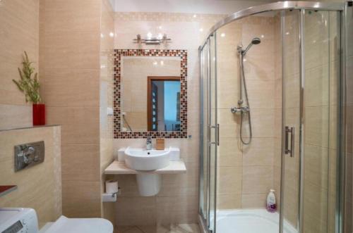 a bathroom with a shower and a sink and a toilet at Golden Apartments Warsaw - Big and Bright Apartment in Platinum Towers- Browary- Grzyb61A in Warsaw