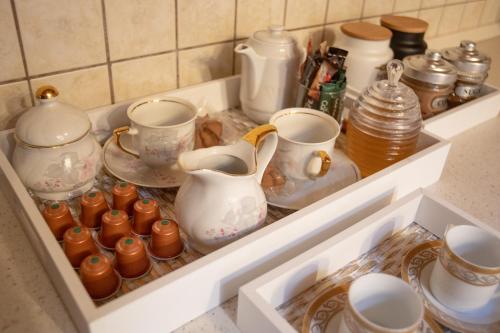 a drawer full of dishes and cups and pitchers at Soffitta House Sofi! in Florina
