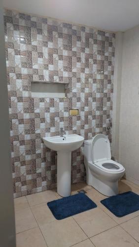 a bathroom with a toilet and a sink at Marino Transient House in Alaminos