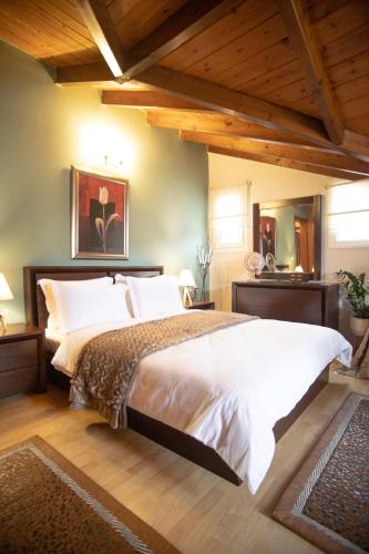 a bedroom with a large bed and wooden ceilings at Soffitta House Sofi! in Florina