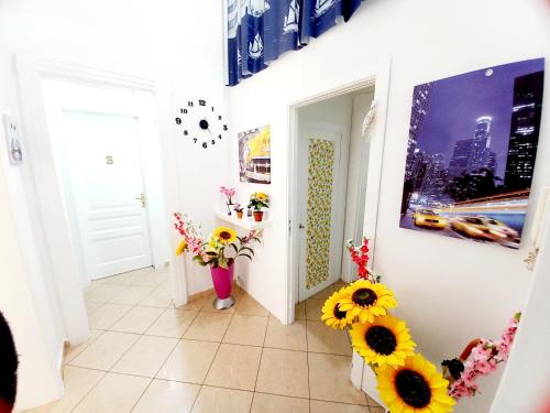 einen Flur mit Sonnenblumen in Vasen auf dem Boden in der Unterkunft B&B Family - Affitta camere in Reggio di Calabria