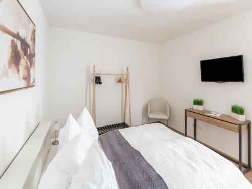 a bedroom with a bed and a tv on a wall at Cozy holiday home in Bavaria in a charming area in Beilngries