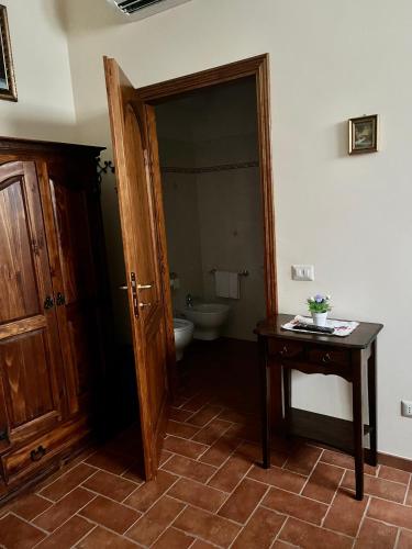 a bathroom with a toilet and a table and a door at Agriturismo IL VIAIO in Fiesole