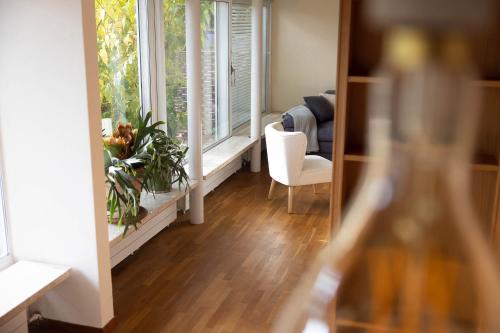 a room with a window and a table and a chair at Luxury apartment with terrace and garden free parking smart TV etc in St. Gallen