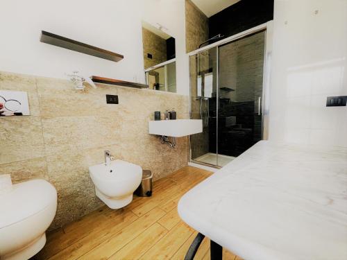 a bathroom with a sink and a toilet and a shower at B&B Villa Incrocca in Cerreto dʼEsi