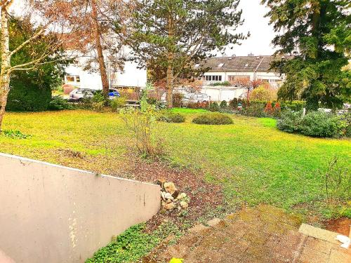 un patio con una pared de retención y un patio con una casa en Banaba en Wiesbaden