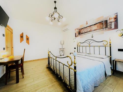 a bedroom with a bed and a table and a desk at B&B Villa Incrocca in Cerreto dʼEsi