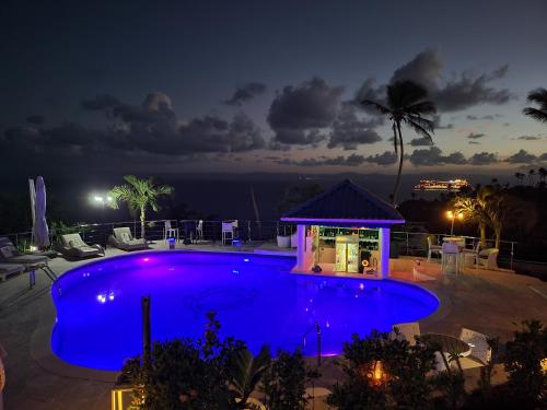 a swimming pool at night with a gazebo at casaenjoysamana in Los Naranjos