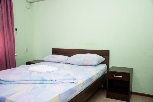 a bed with two pillows on it in a room at Motel Aura in Višegrad
