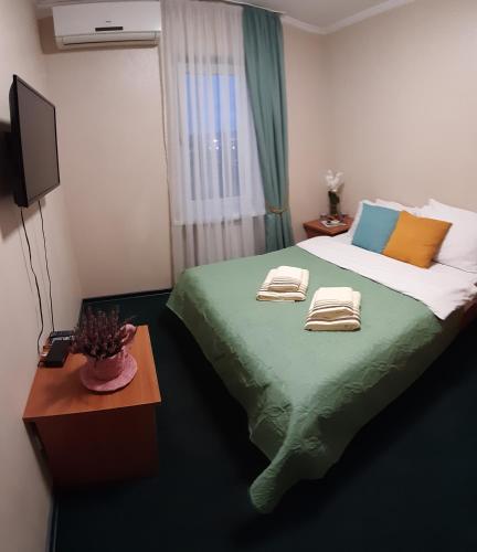 a bedroom with a bed with two towels on it at Готель "Опалковий Замок" in Kyiv