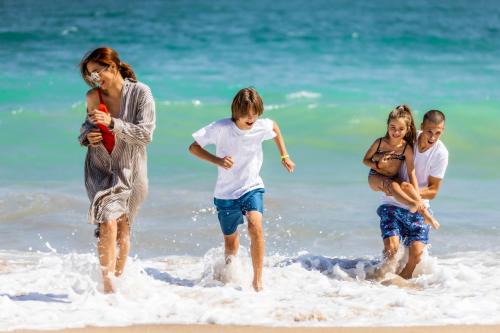 a group of people playing in the water at the beach at Prestige Deluxe Hotel Aquapark Club - All inclusive in Golden Sands