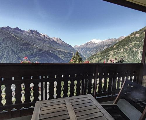 a balcony with a table and a view of mountains at Berghotel Weisshorn in Törbel