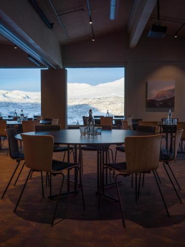 a dining room with a large table and chairs at Skarsnuten Mountain Resort & SPA in Hemsedal