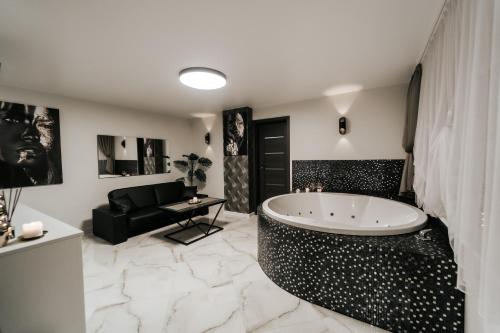a large bathroom with a tub in the middle at Kiss Apartment in Šilutė