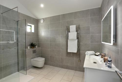 a bathroom with a shower toilet and a sink at Boat House Lodge in Shrewsbury