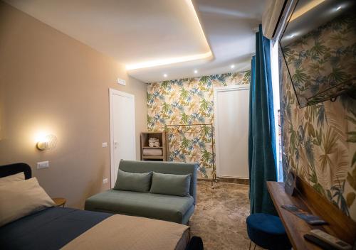 a bedroom with a bed and a chair and a window at Le stanze di Cloe in Naples