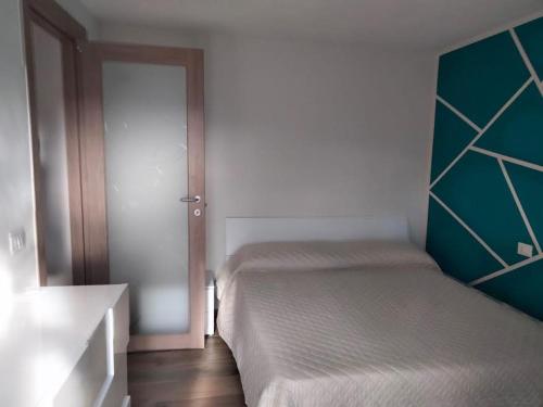 ein kleines Schlafzimmer mit 2 Betten und einer Tür in der Unterkunft Green House 2.0 in Pieve di Teco