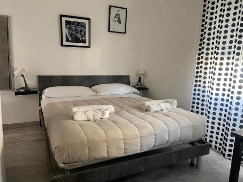 a bed in a bedroom with two towels on it at B&B FRONTEMARE San Salvo Marina CH in San Salvo