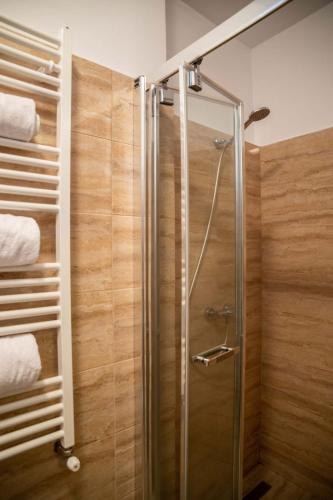 a shower with a glass door in a bathroom at Oldtownvilla apartament in Sibiu