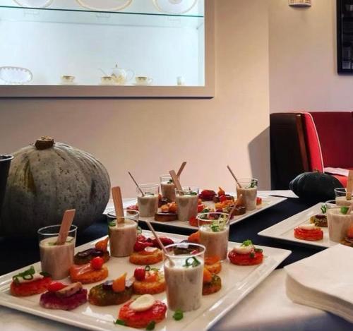 a table with several plates of food and drinks at Hôtel du Golf Saint Lazare in Limoges