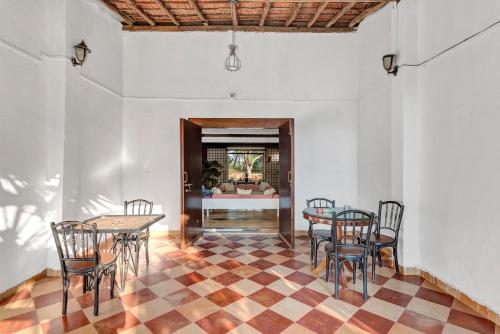 a dining room with a table and chairs at SaffronStays Laburnum House, Wada - Palghar in Wada