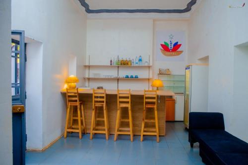 a kitchen with a table with chairs and a couch at LOTUS HOTEL in Diego Suarez