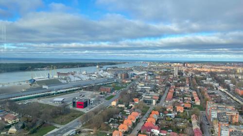 an aerial view of a city with a river and buildings at 34 floor at the top of the Baltic in Klaipėda