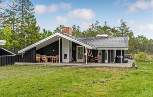 a house with a porch and a lawn at Awesome Home In Skagen With Wifi in Skagen