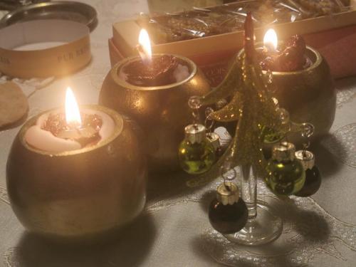 a group of candles and christmas ornaments on a table at La casa di Ciaccia in Camaiore