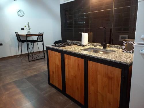 a bathroom with a sink and a counter with a table at Departamento 2448 in Mina Clavero