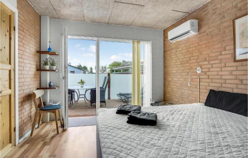 ein Schlafzimmer mit einem Bett und einer Ziegelwand in der Unterkunft 1 Bedroom Amazing Apartment In Hjrring in Hjørring