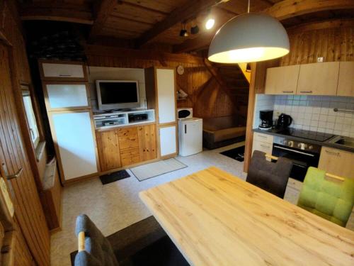 a kitchen with a wooden table in a room at Ferienhaus am Eichert in Furth im Wald
