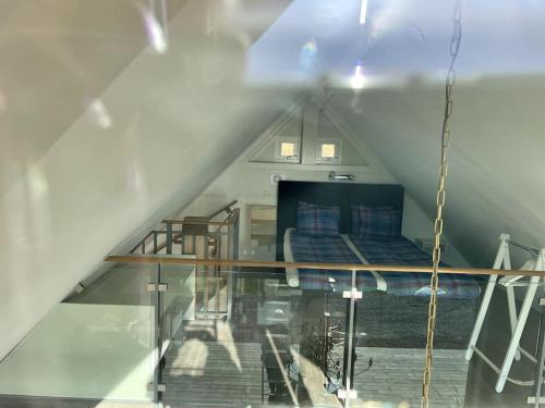 a room with a bed in a attic at Lovely house on beautiful private lakeside estate! in Bunn