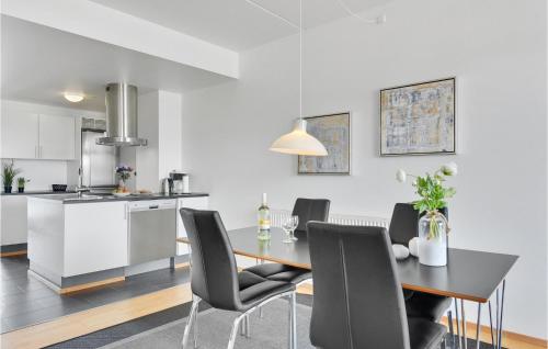 a kitchen and dining room with a table and chairs at One-Bedroom Apartment In Romo in Havneby