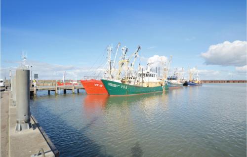 a group of boats docked at a dock in the water at One-Bedroom Apartment In Romo in Havneby
