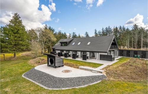 an aerial view of a home with a black roof at 2 Bedroom Cozy Apartment In Blokhus in Blokhus