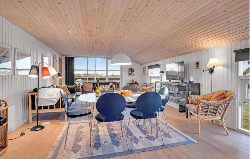 a kitchen and living room with a table and chairs at Nice Home In Hjrring With Kitchen in Lønstrup
