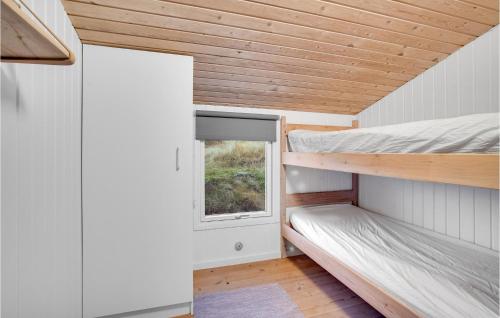 a tiny house with a window and two bunk beds at Holiday Home Harrerenden Hjørring Iii in Lønstrup