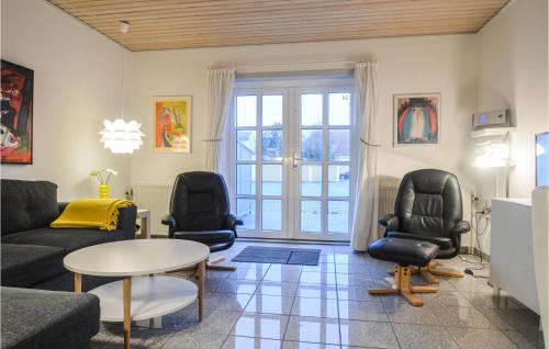 a living room with a couch and chairs and a table at Two-Bedroom Apartment In Lokken in Løkken