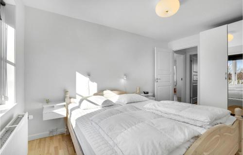 a white bedroom with a large bed with white sheets at Gorgeous Apartment In Skagen With Kitchen in Skagen