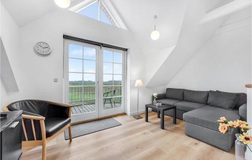 a living room with a couch and a window at Holiday Home Vestergade Rømø in Rømø Kirkeby