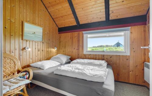 a bedroom with a bed in a wooden wall at Beautiful Home In Hjrring With 3 Bedrooms And Wifi in Lønstrup