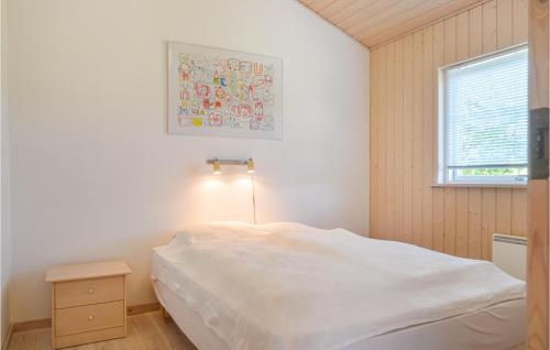 a bedroom with a white bed and a window at Gorgeous Home In Lkken With Sauna in Løkken