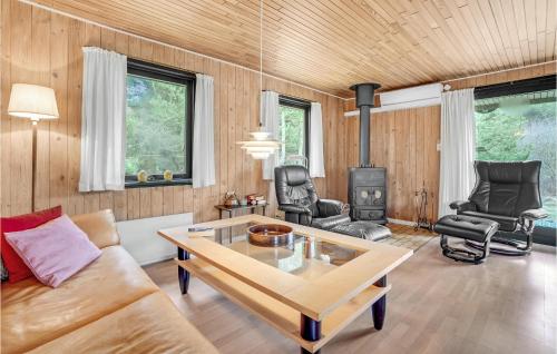 a living room with a couch and a stove at Holiday Home Østkrogen Blåvand X in Blåvand