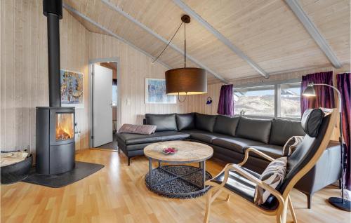 a living room with a couch and a fireplace at Holiday Home Rauhesvej Ix in Bjerregård