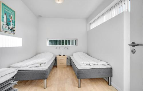 two beds in a room with white walls at 3 Bedroom Gorgeous Home In Ålbæk in Ålbæk