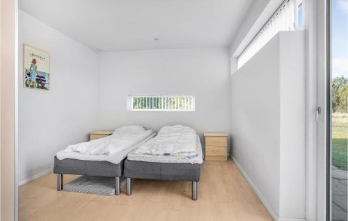 a bed in a white room with a window at 3 Bedroom Gorgeous Home In Ålbæk in Ålbæk